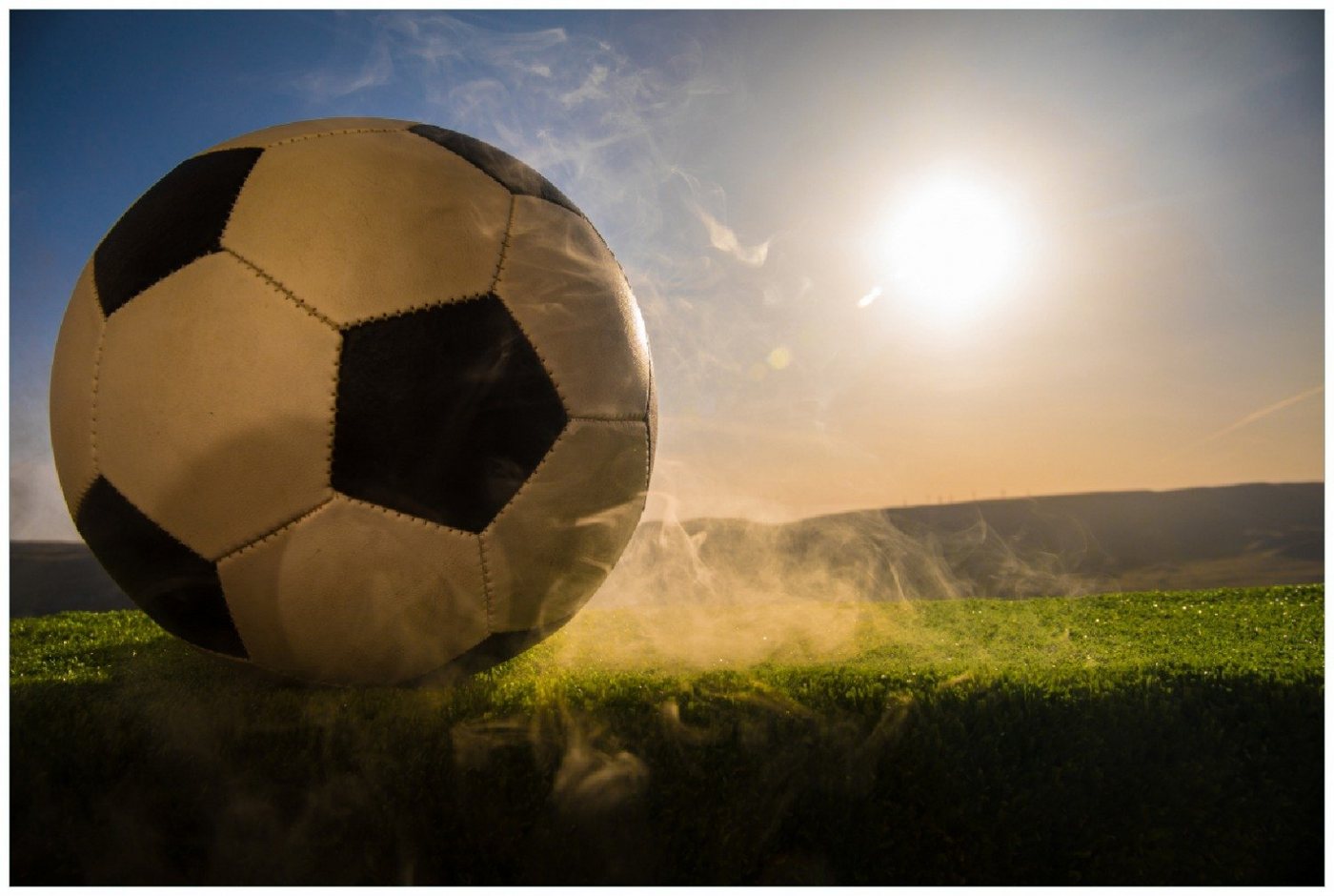 Wallario Poster, Fußball bei Sonnenuntergang, in verschiedenen Ausführungen von Wallario